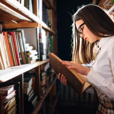 woman reading a book in the old library