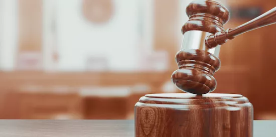 Wooden gavel on table close up.