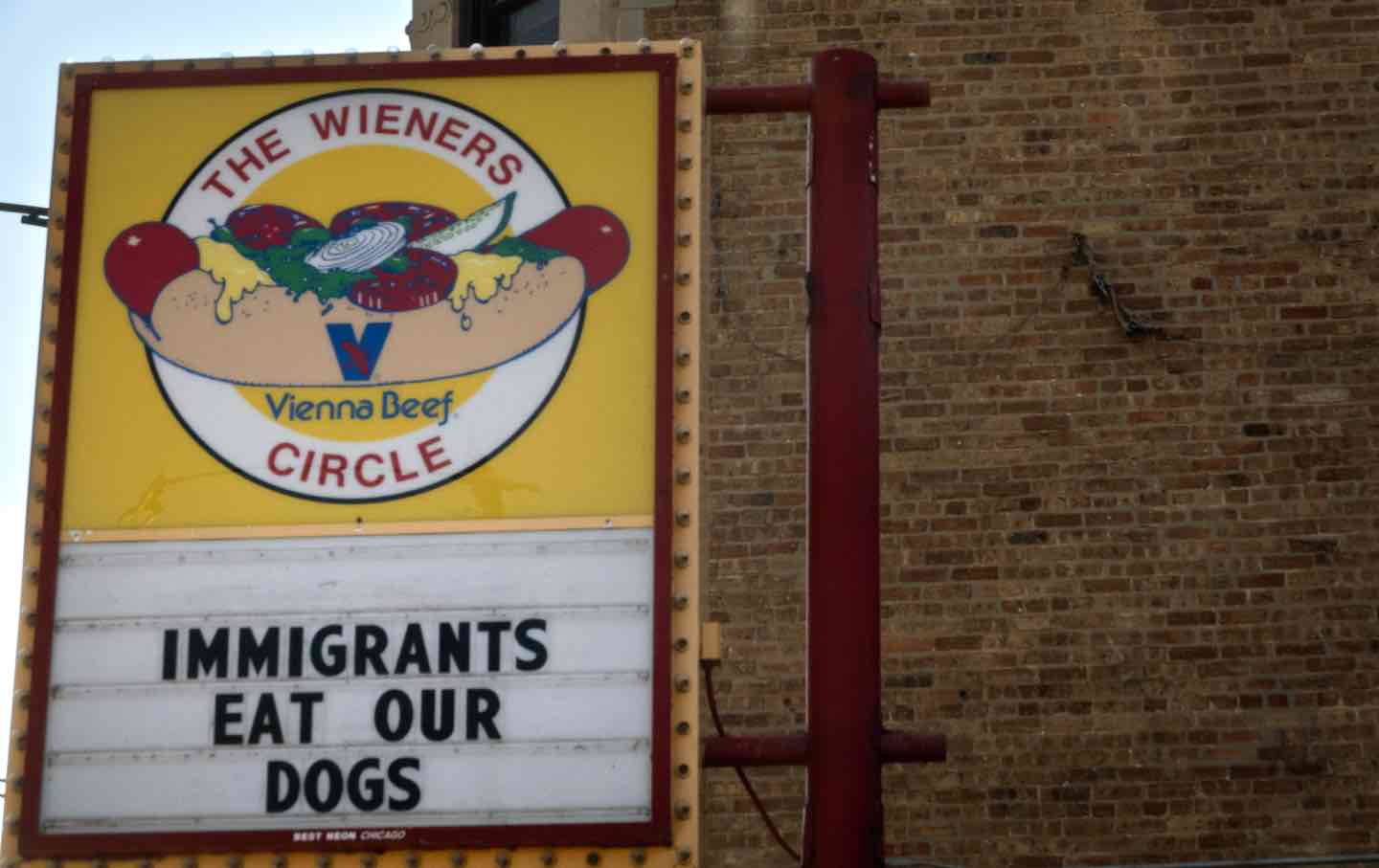 A sign at The Wieners Circle, a popular hot dog restaurant in Chicago, reads “IMMIGRANTS EAT OUR DOGS” in response to a statement made by former president Donald Trump during his Tuesday-night debate against Vice President Kamala Harris.