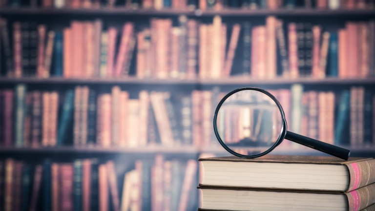 Books and magnifying glass