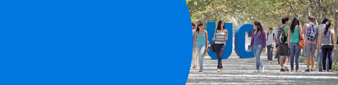 Students walking in front of a UC big blue letters.