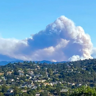 In this photo from August 19, 2020, smoke billows over the CZU Lightning Complex fires, as seen from the southern San Francisco Bay. The fires tragically killed one person and destroyed 1,490 buildings, including many beloved homes in the wildland-urban interface in Santa Cruz County. Photo: Bruce Washburn, www.flickr.com/btwashburn