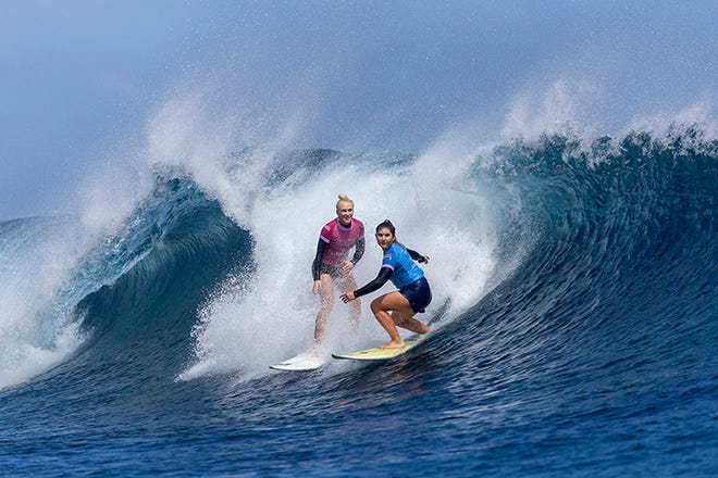 (L-R) Tatiana Weston-Webb of Team Brazil and Brisa Hennessey of Team Costa Rica ride the same wave during the semifinals of surfing on day nine of the Olympic Games Paris 2024 on August 5, 2024 in Teahupo'o, French Polynesia. Hennessey was assessed a wave priority violation.