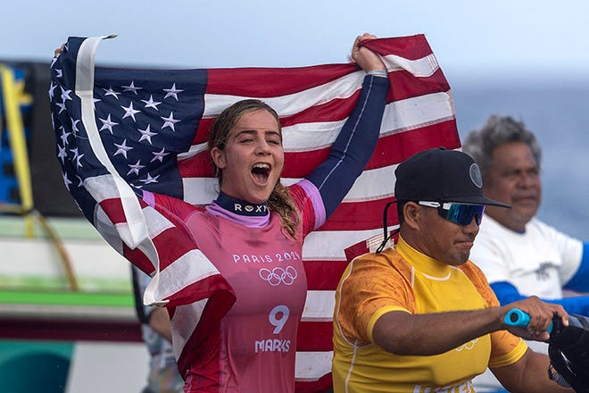 Caroline Marks of Team United States celebrates after winning the women's Gold Medal of surfing on day nine of the Olympic Games Paris 2024 on August 5, 2024 in Teahupo'o, French Polynesia