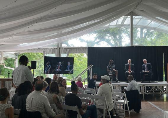 An audience participant asking a question. Pictured from left to right on stage: USDA Chief Scientist and Under Secretary for Research, Education, and Economics Dr. Chavonda Jacobs-Young, Agriculture Secretary Tom Vilsack, and Pennsylvania Department of Agriculture Secretary Russell Redding